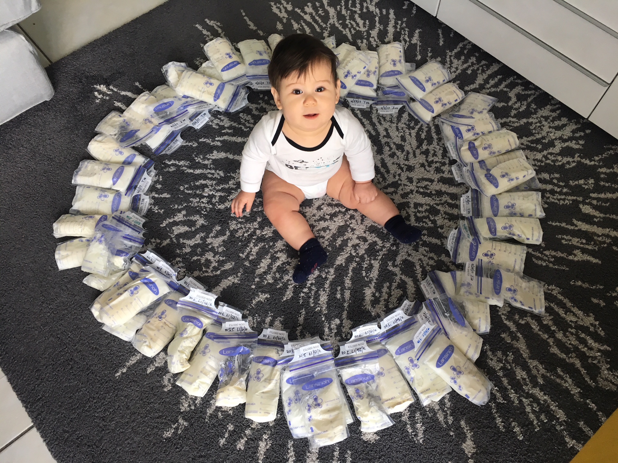 infant inside a ring of milk bags
